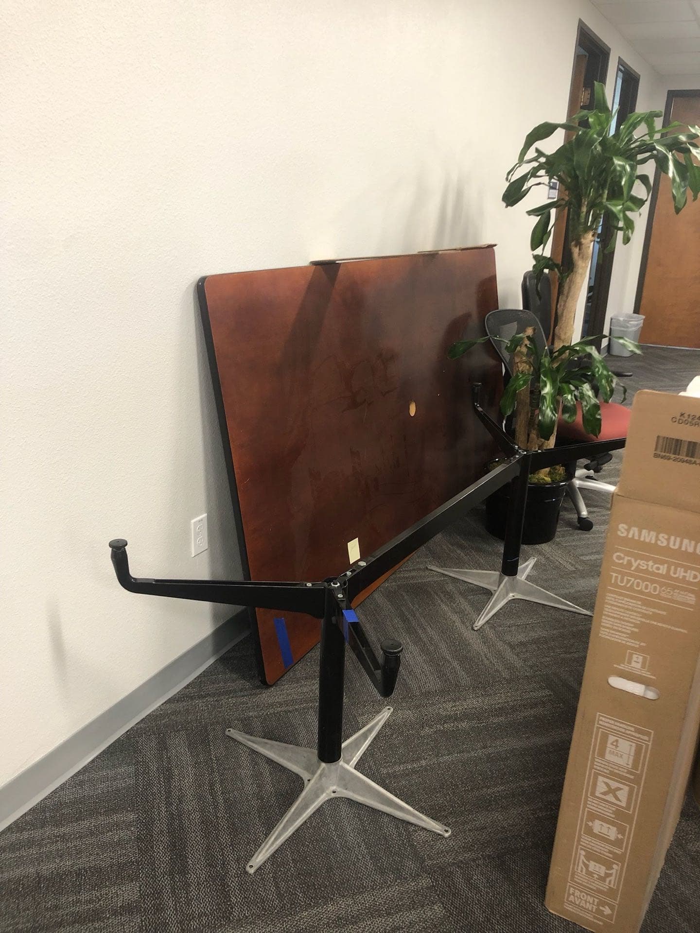 Folded conference tables and equipment left for JunkMD+ office cleanout in a San Diego workplace