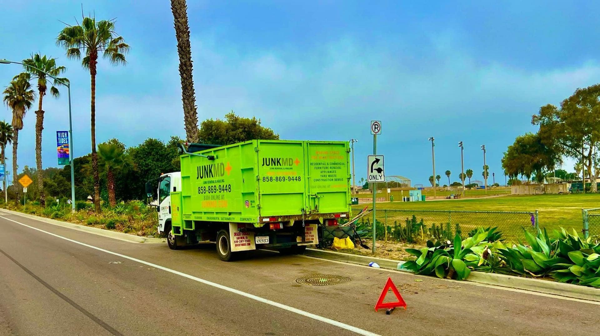 JunkMD+ green junk-removal truck on a Fallbrook, San Diego route
